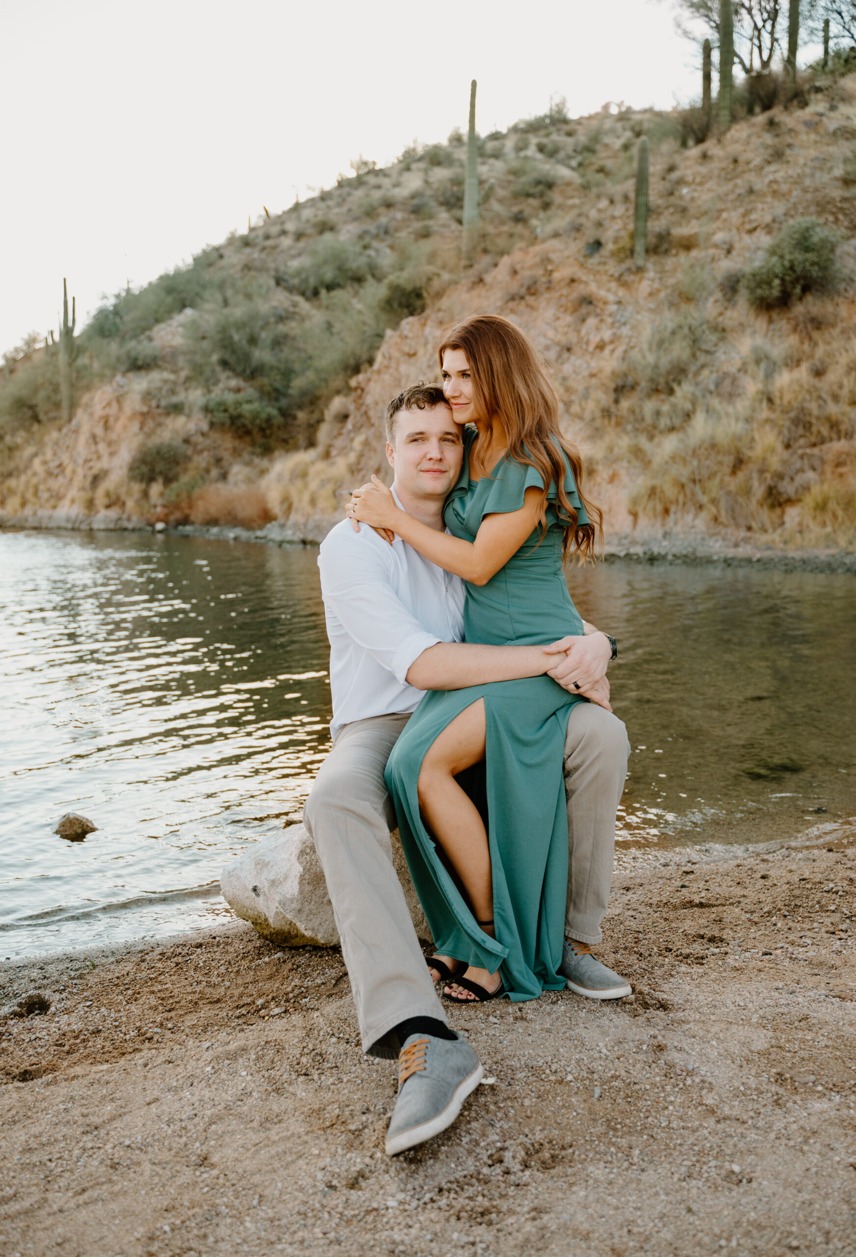 Couple embraces at Saguaro Lake smiling