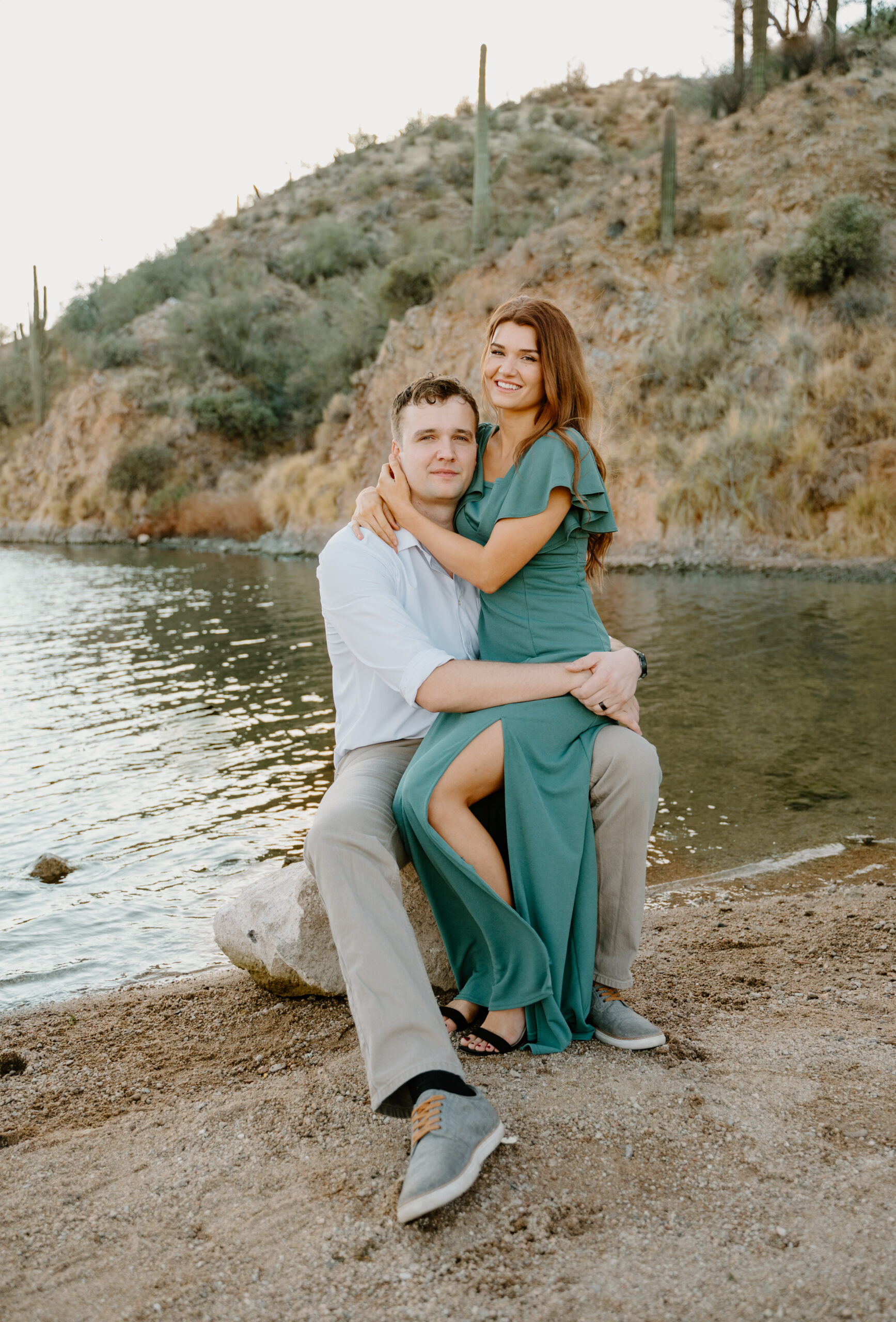 Couple embraces at Saguaro Lake smiling