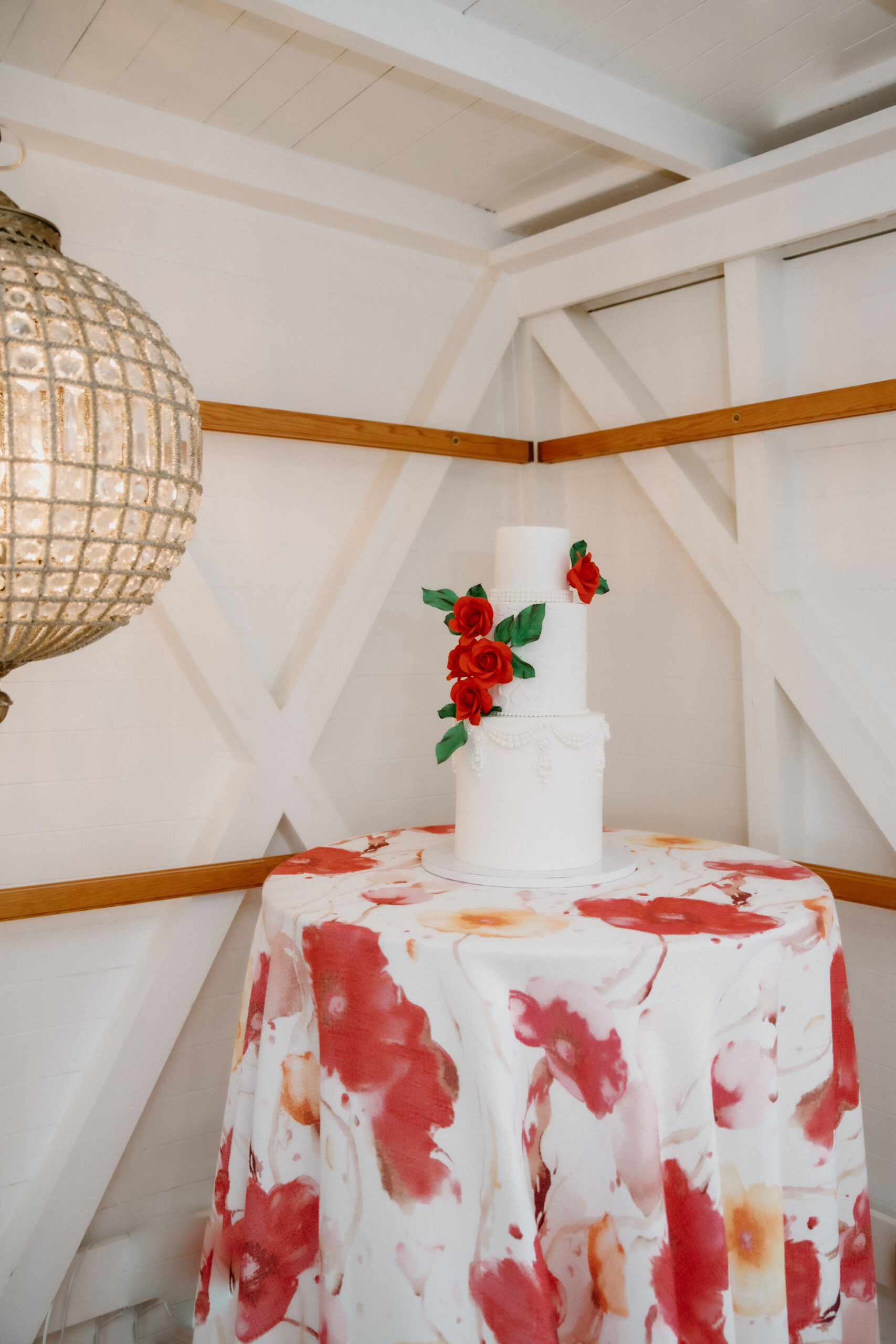 White Wedding Cake with red roses