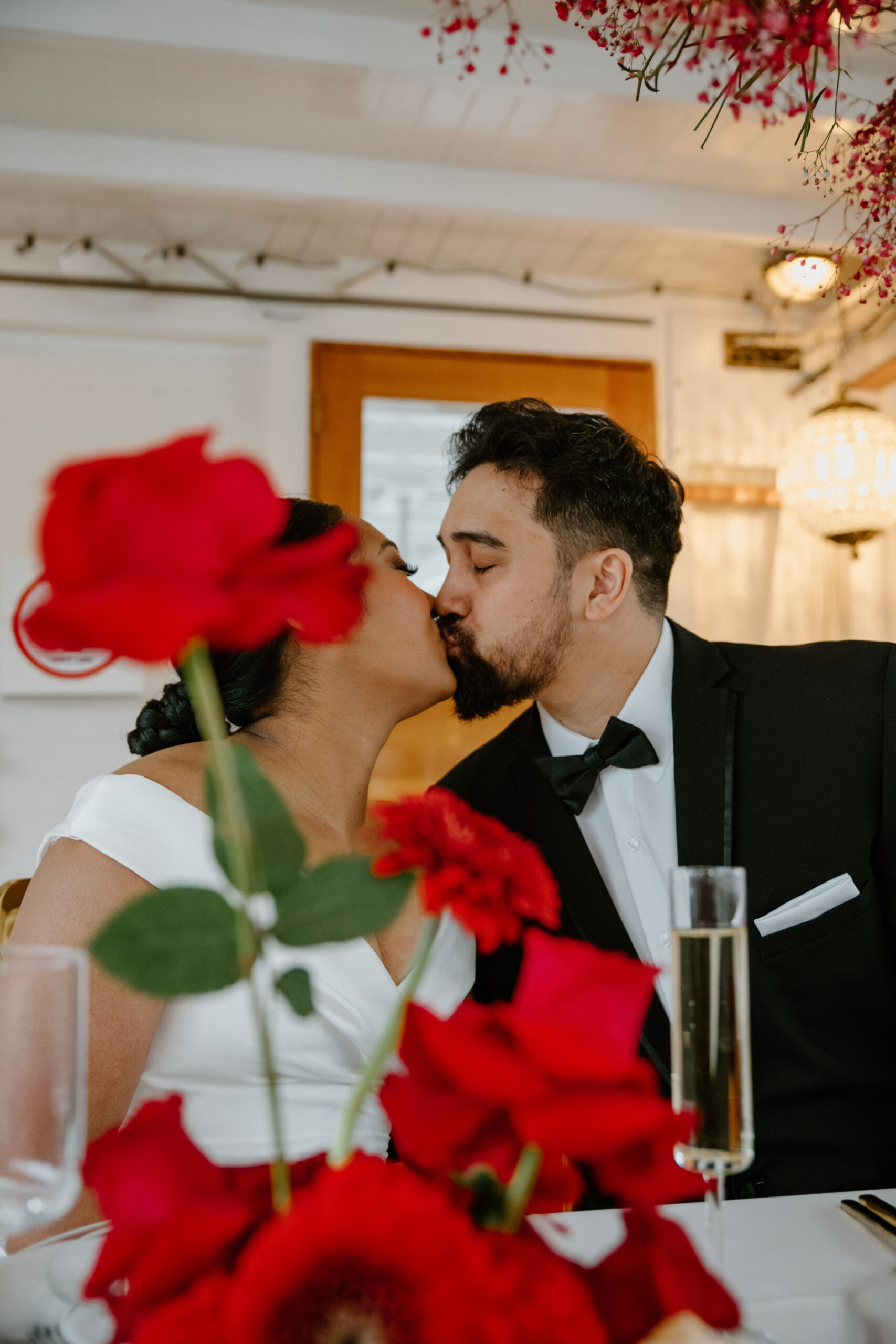 Bride and groom kissing at their boat wedding reception