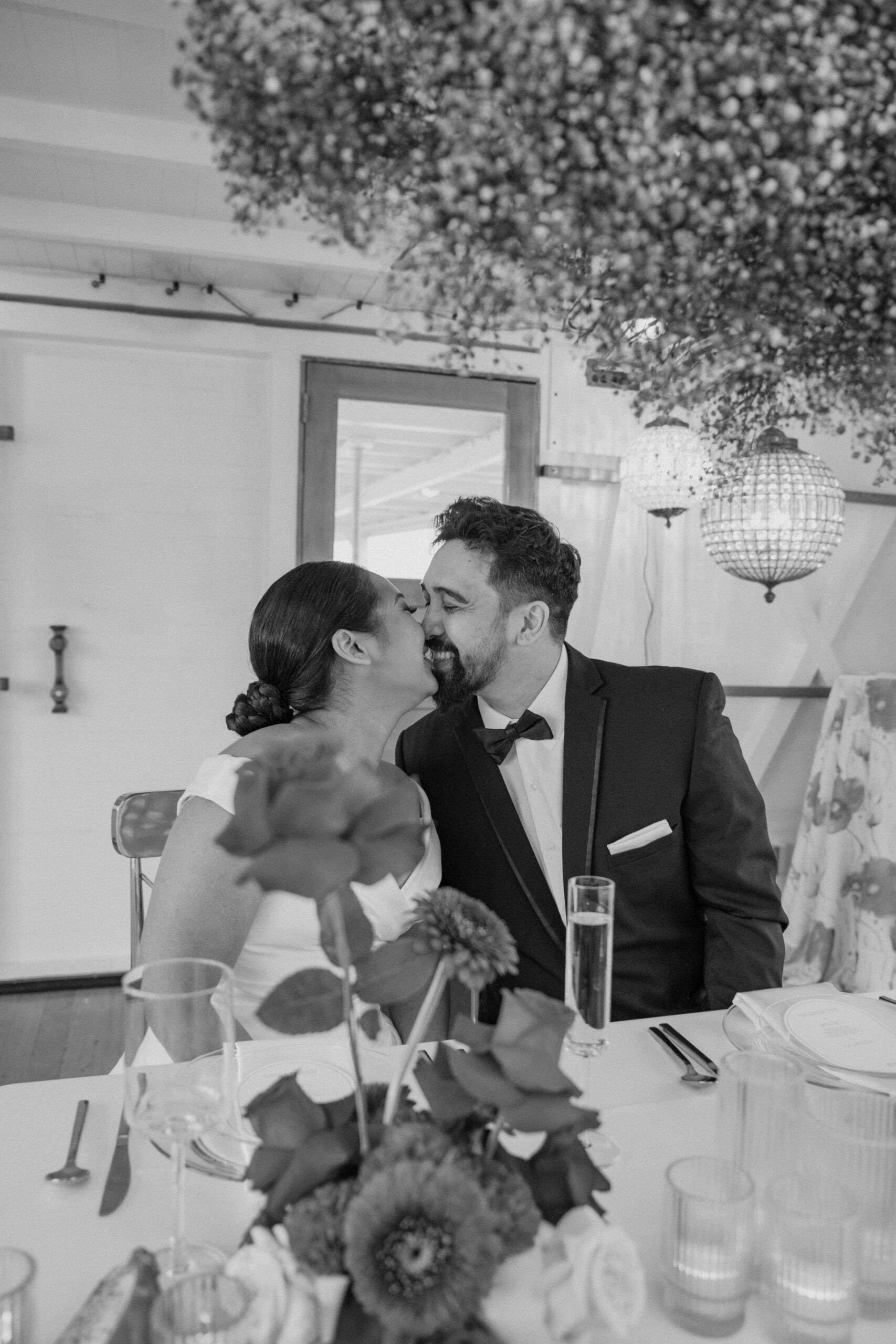 Black and white photo of the bride and groom laughing together at their Virginia wedding venue.