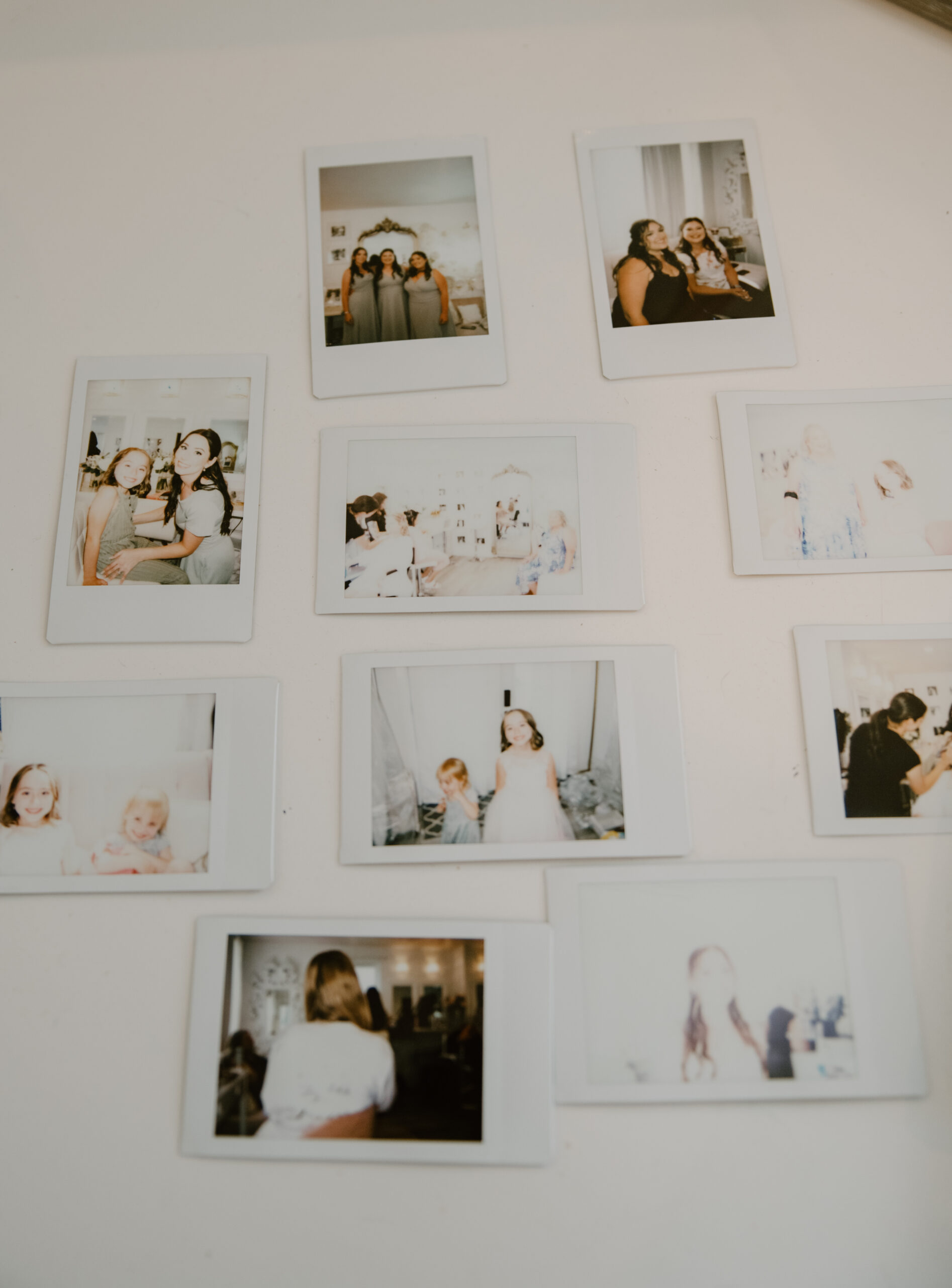 Scattered polaroids show candid moments of bridesmaids and flower girls getting ready before the ceremony.