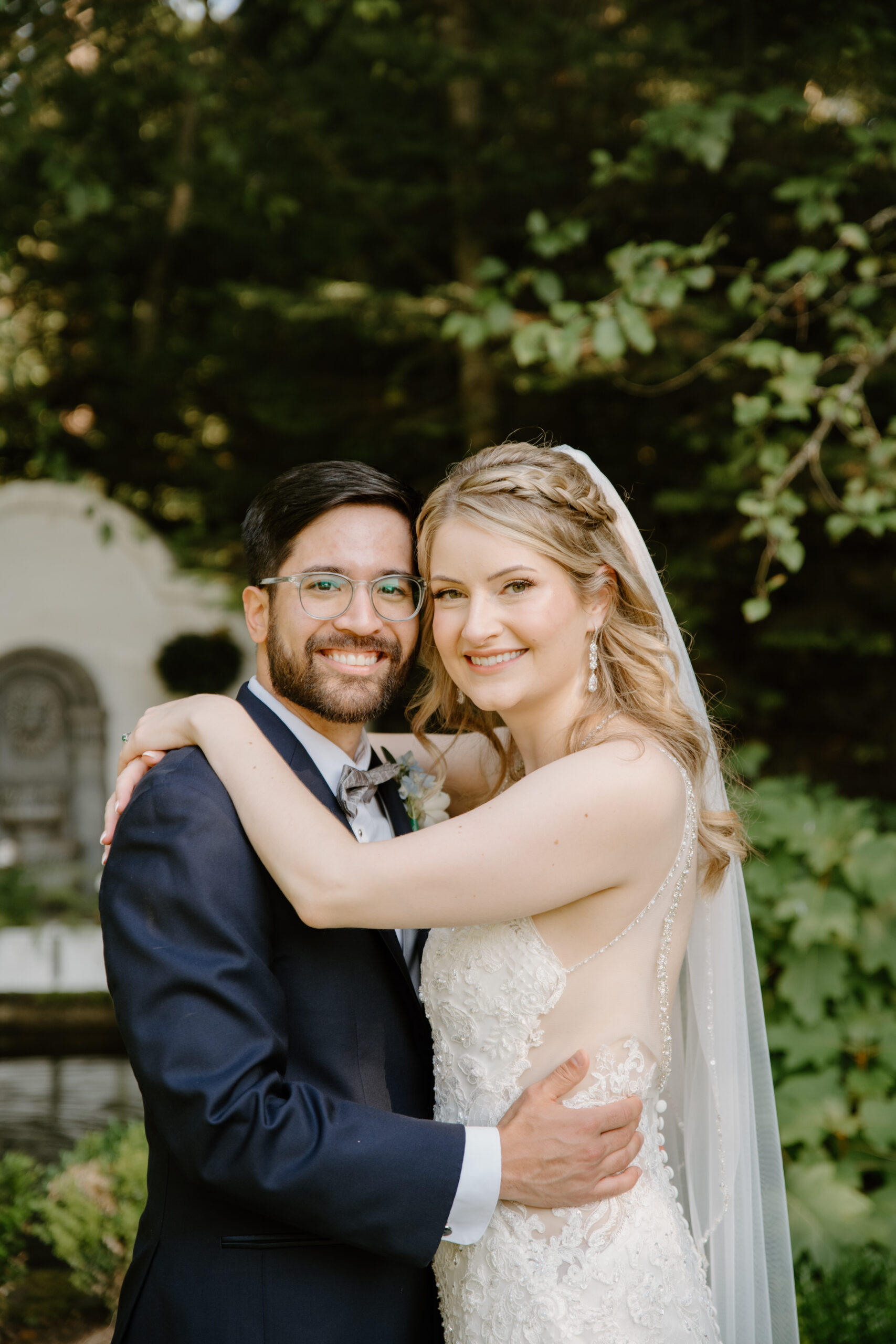 Bride and groom smiling hugging one another