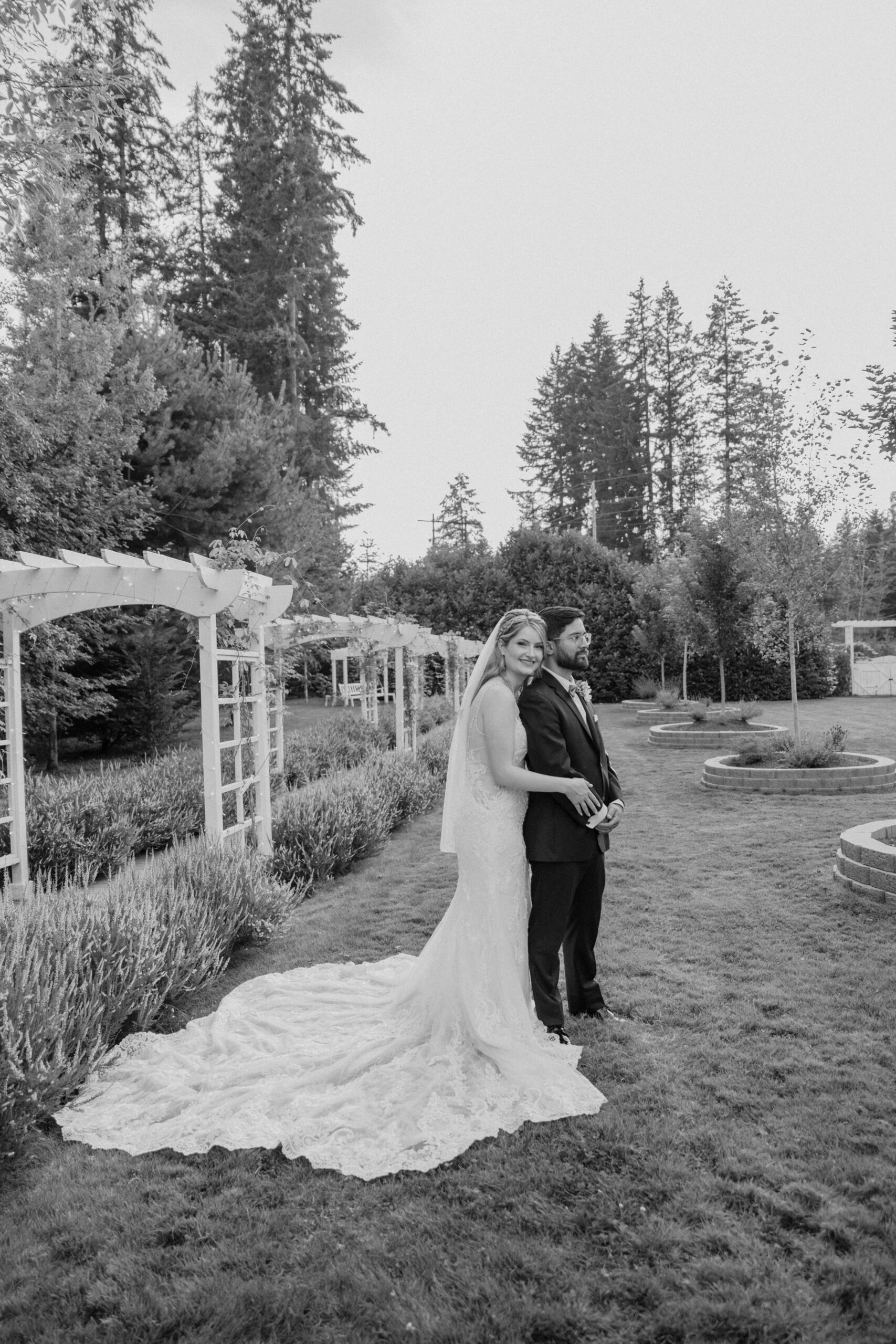 Black and white photo of bride and groom hugging