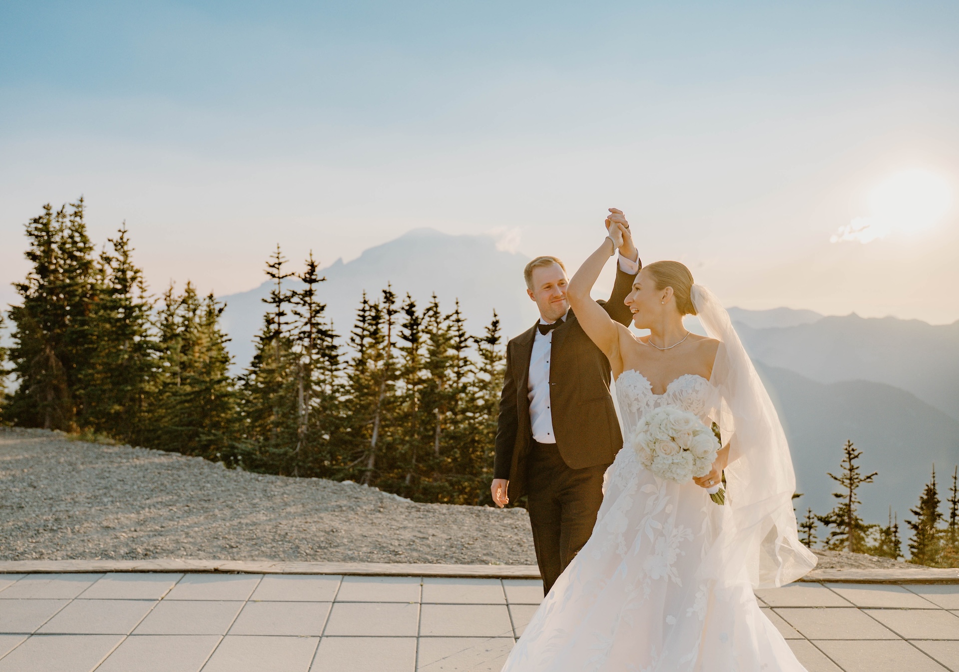 Bride and groom dancing on a mountain patio at sunset with Mount Rainier behind them during a Crystal Mountain Resort Wedding.