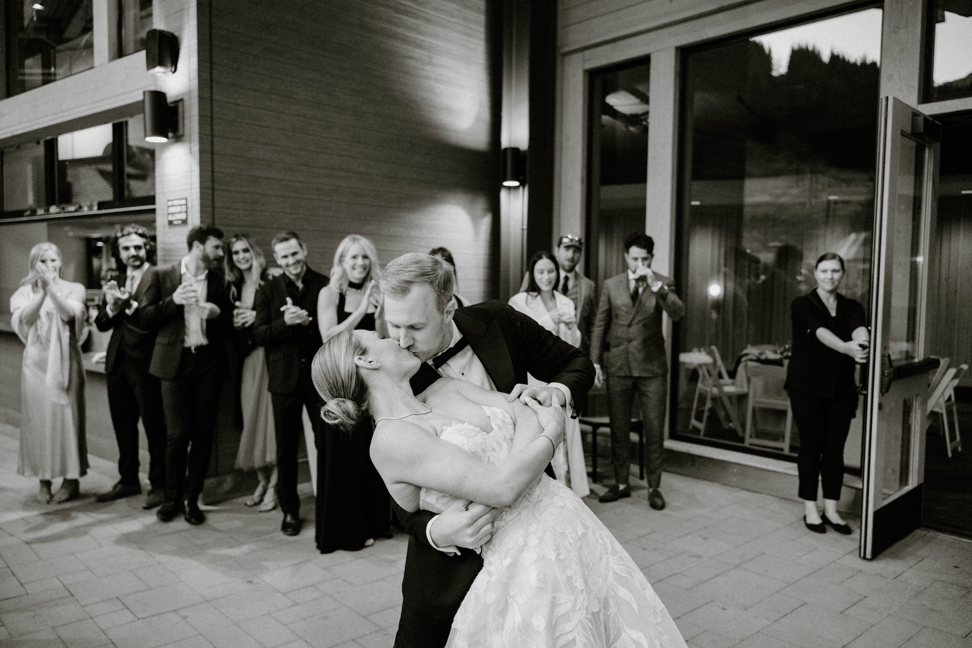 Groom dipping the bride during their first dance outside the venue at a Crystal Mountain Resort Wedding celebration.