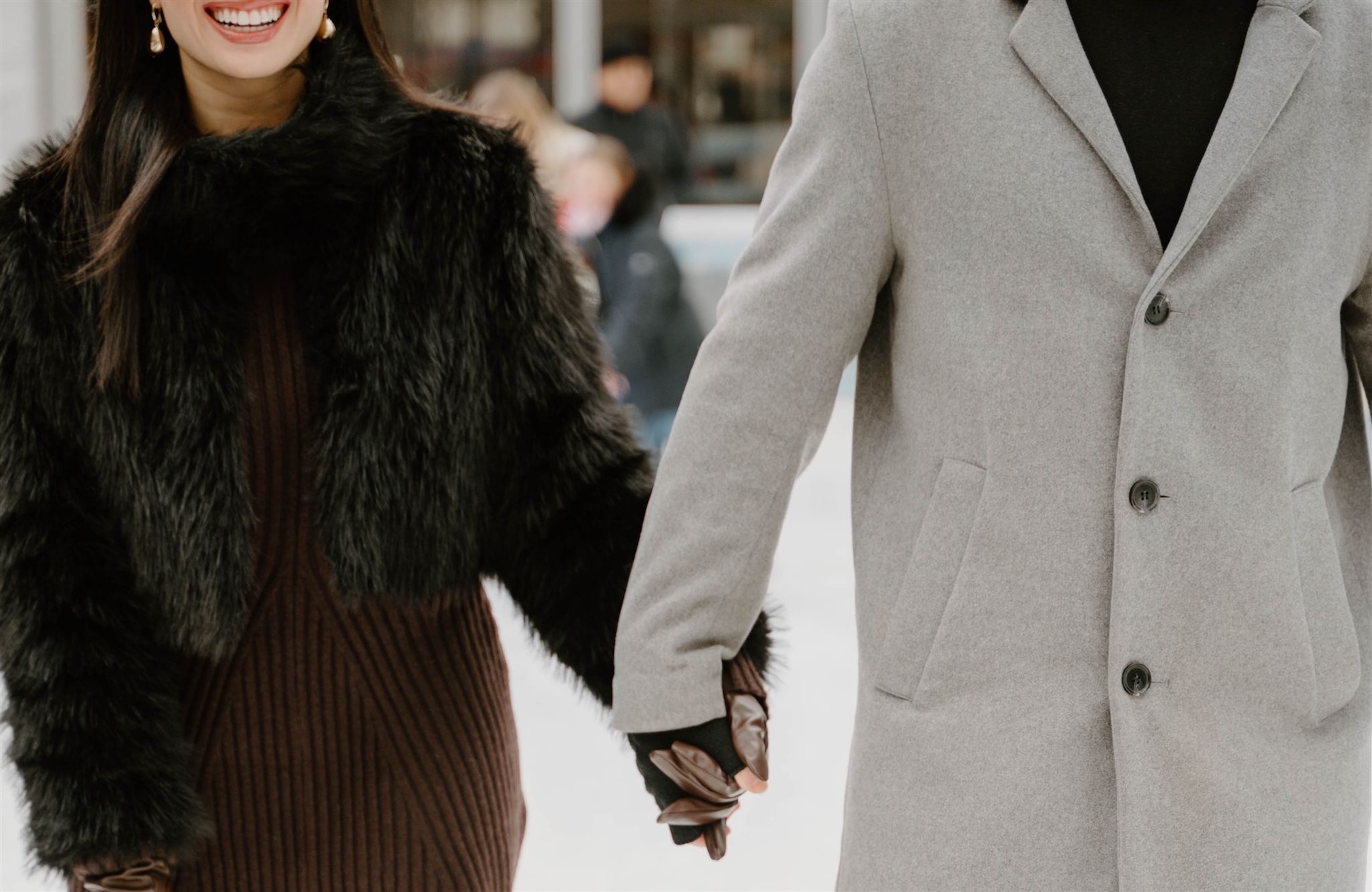 Romantic engagement photos in New York City of a couple enjoying a festive ice skating date at Bryant Park during winter.
